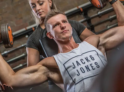 Trainer Assisting Client